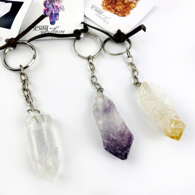 One of each of the Crystal Quartz Point, Amethyst point and Citrine Point keychains up close