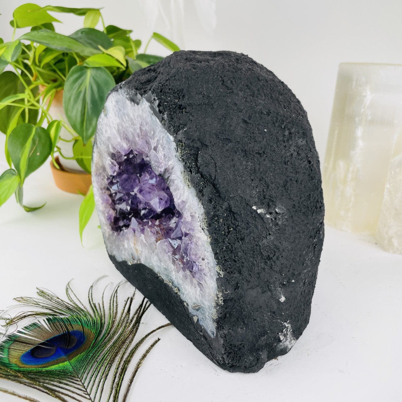 side view of Amethyst Cathedral Geode Crystal with decorations in the background