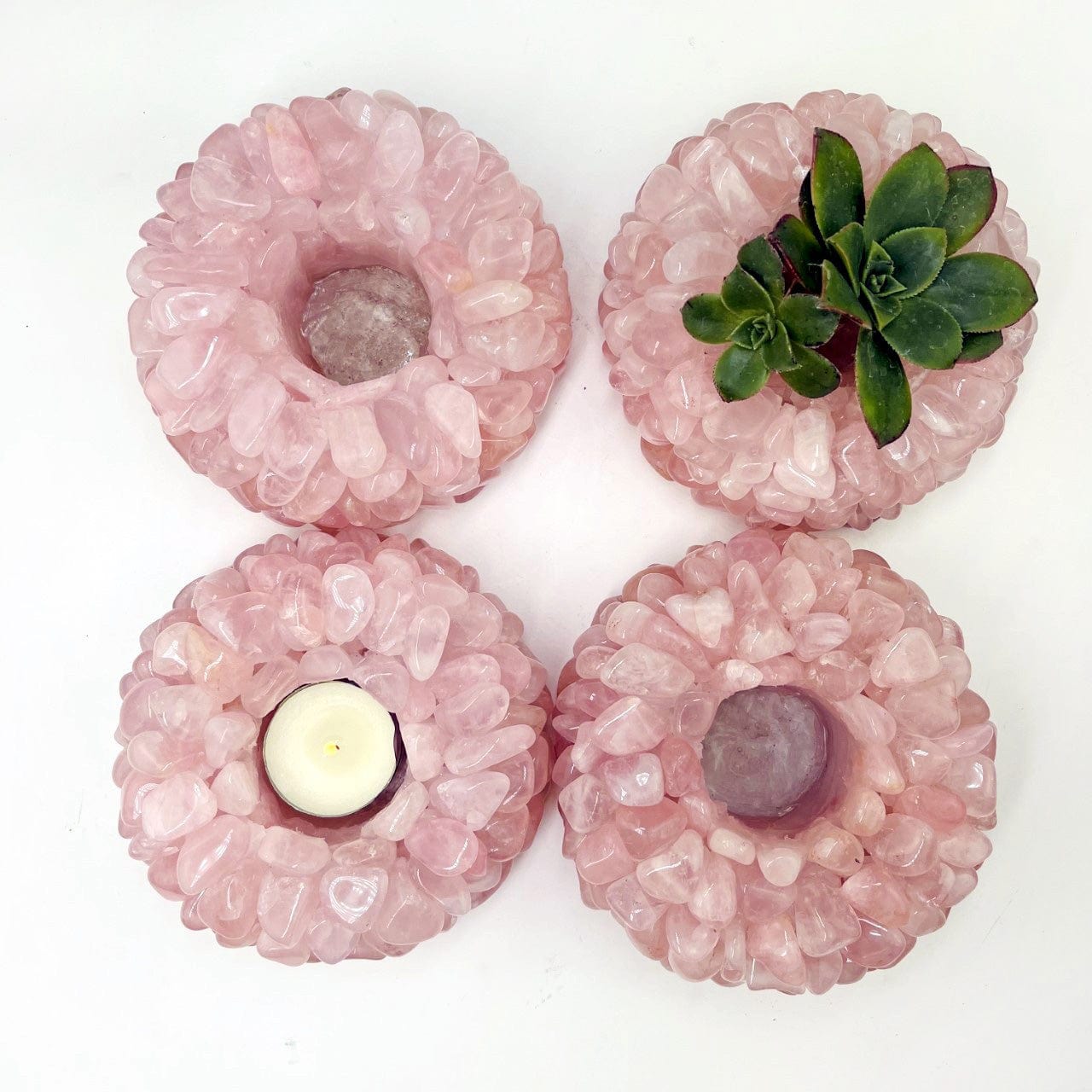 4 Rose Quartz Tumbled Crystal Candle Holders from over head one with a plant and one with a candle