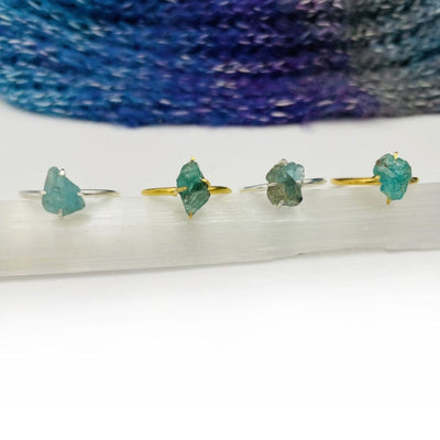Fluorite Gemstone Rings in Gold and Silver on selenite stick
