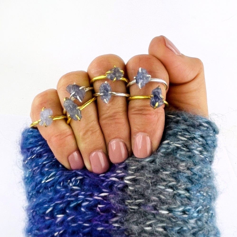 Tanzanite Gemstone Rings in Gold and Silver on a hand