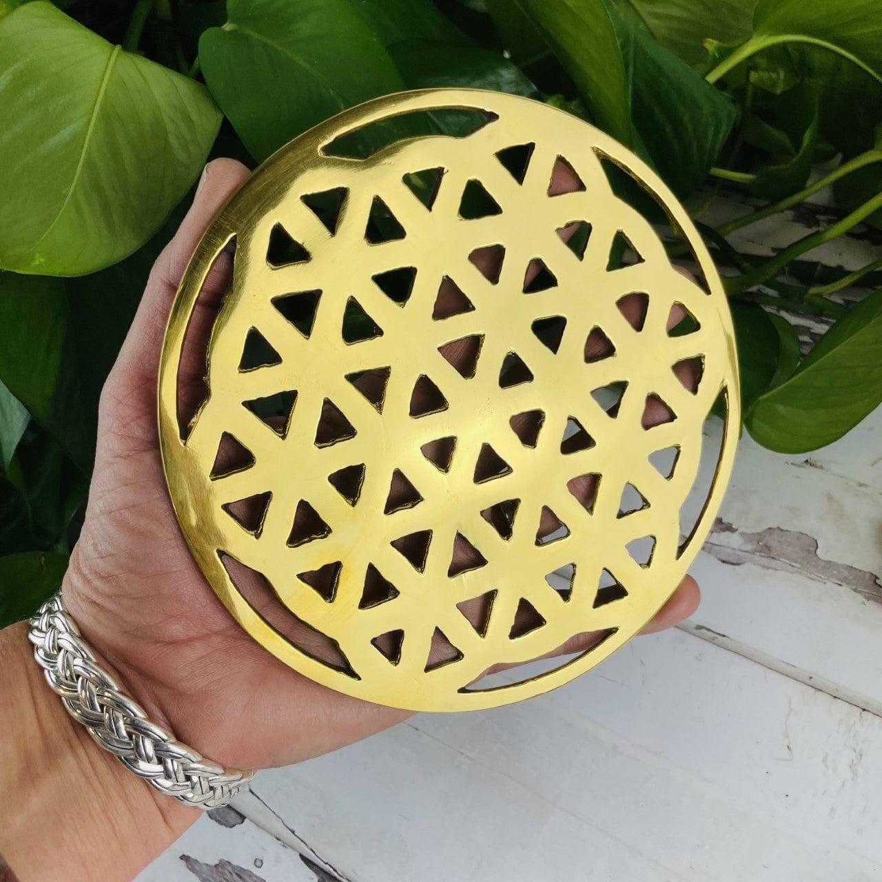 Brass Flower of Life Grid in a hand