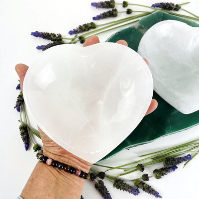 selenite heart bowl in hand for size reference