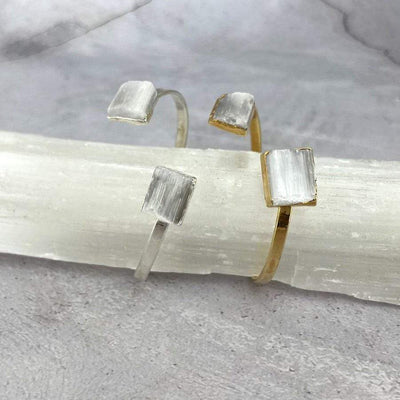 silver and gold selenite cuff bracelets on display