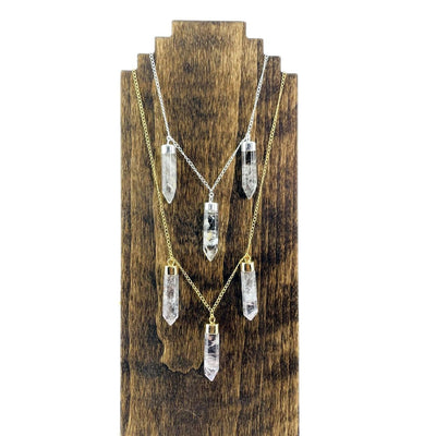 Triple Point Crystal Dangle Pendant Necklace on 18" gold or silver plated chain displayed on wooden necklace stand