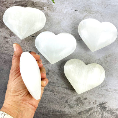  Selenite Heart Shaped Stone - 10cm with one in hand to show sideview of thickness