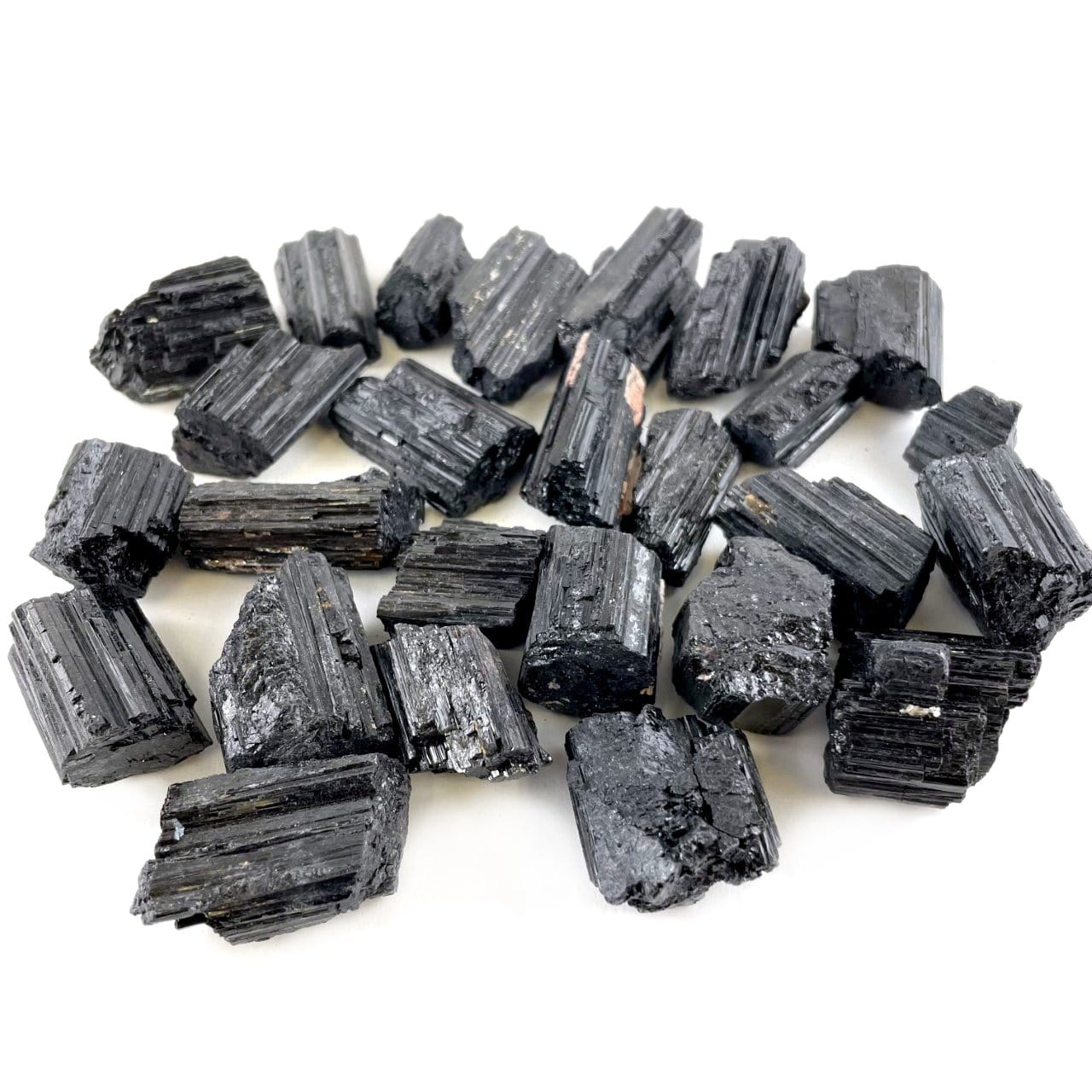 multiple black tourmaline pendant sized rods displaying different sizes and textures