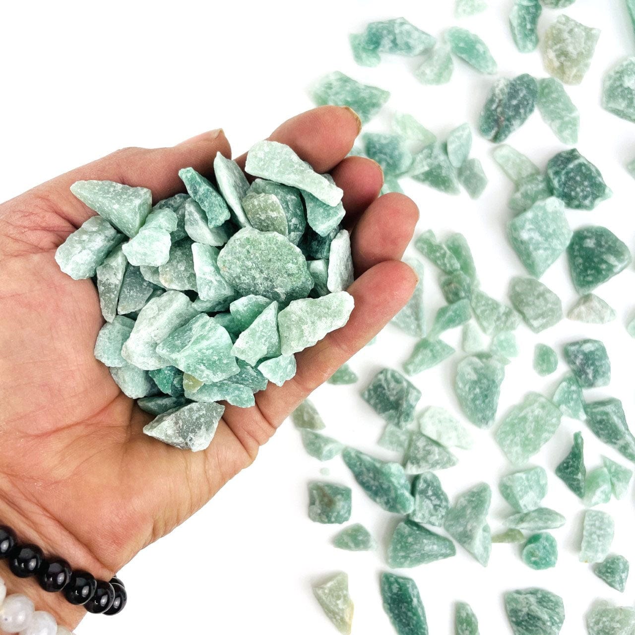 Green Quartz Stones  in a hand for size approximately 150 grams, 1 bag