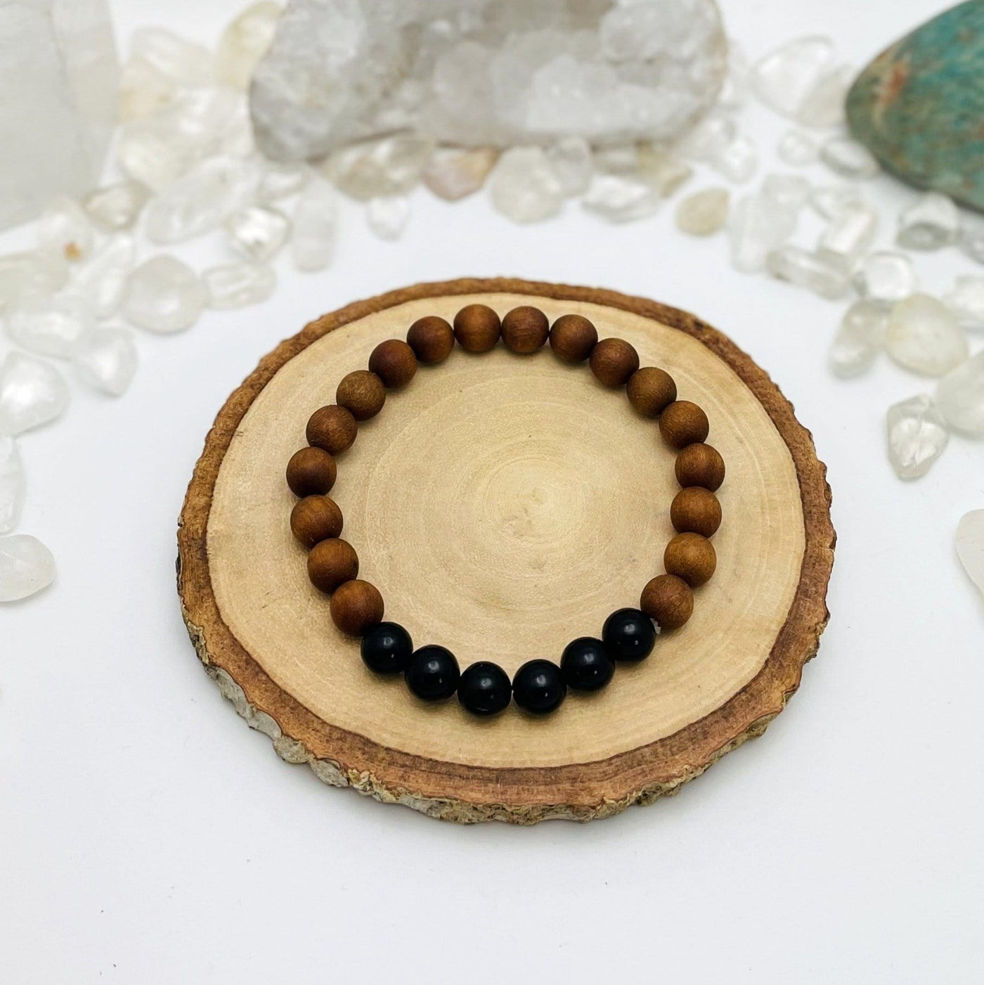 one sandalwood bead bracelet with black obsidian on display for details