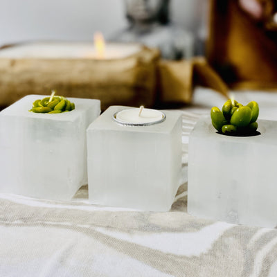 three selenite square candle holders with candles (not included with purchase)