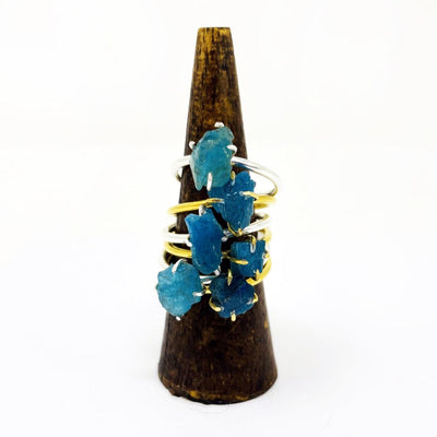 gold and silver Apatite gemstone rings stacked on a holder