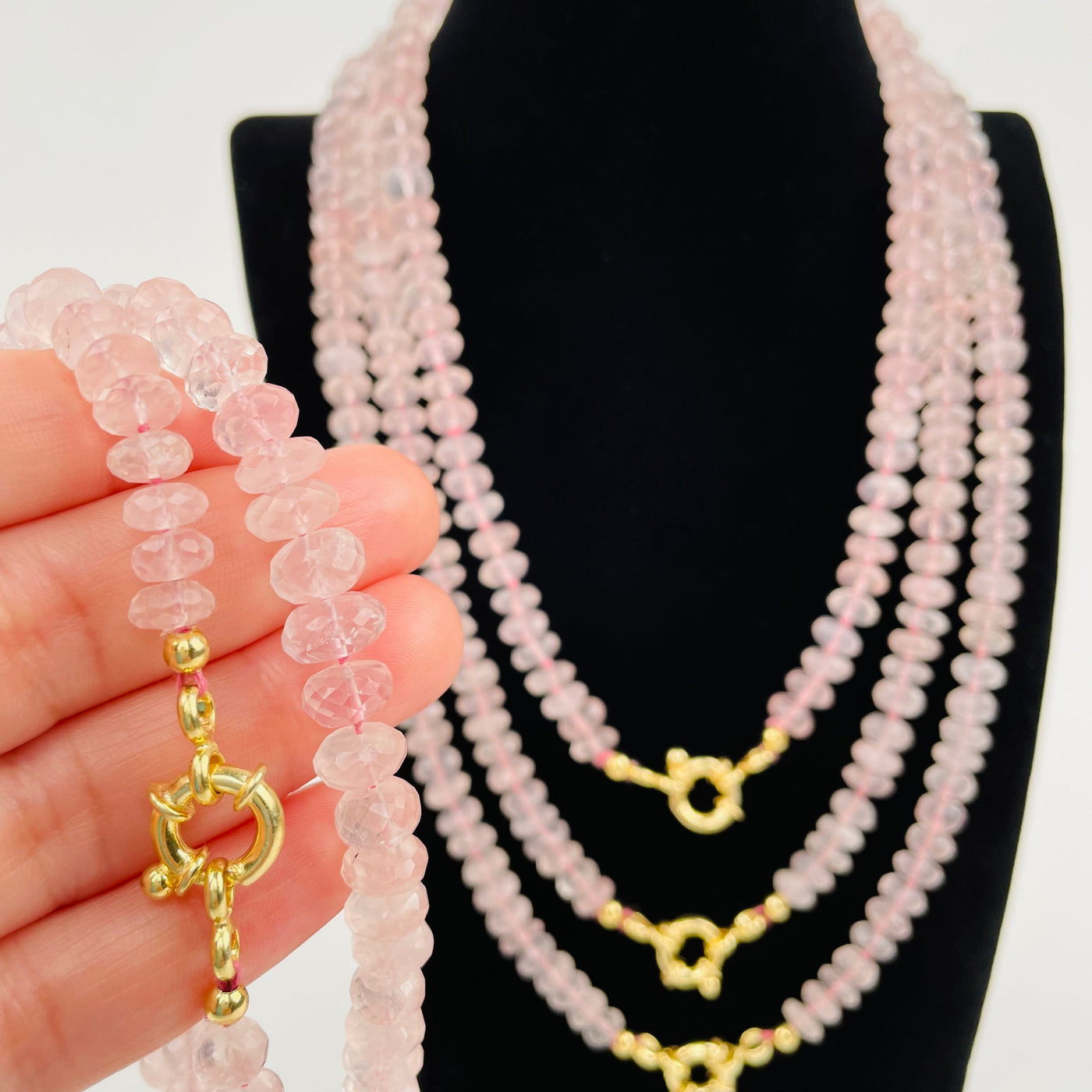 rose quartz candy necklace in hand for size reference 
