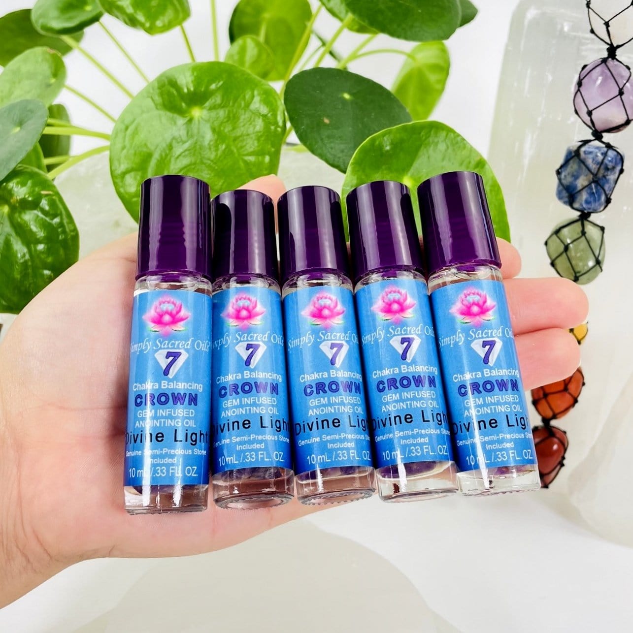 crown chakra oil bottles in a hand - 5