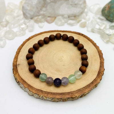 one sandalwood bead bracelet with fluorite on display for details