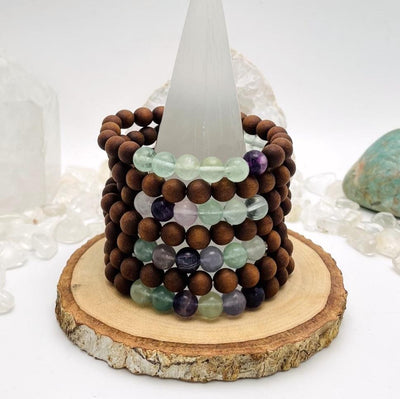 sandalwood bead bracelets with fluorite on display for possible variations