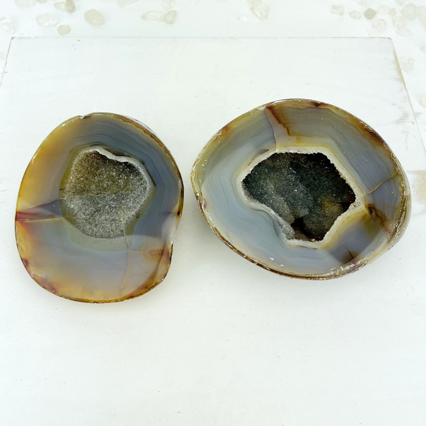 An open agate geode druzy box on a light colored background displaying the druzy and pattern.
