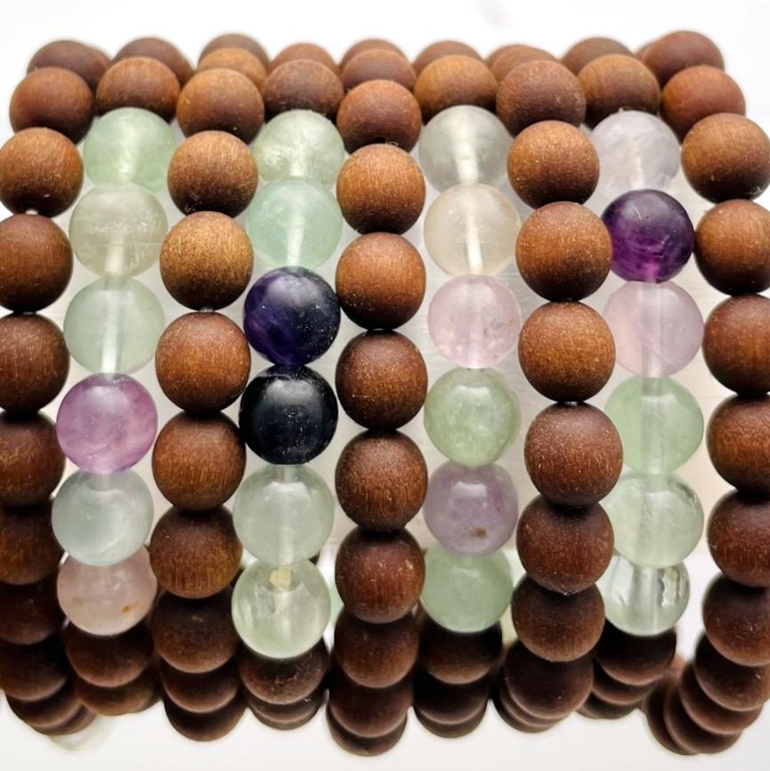 close up of sandalwood bead bracelets with fluorite on display for details and possible variations