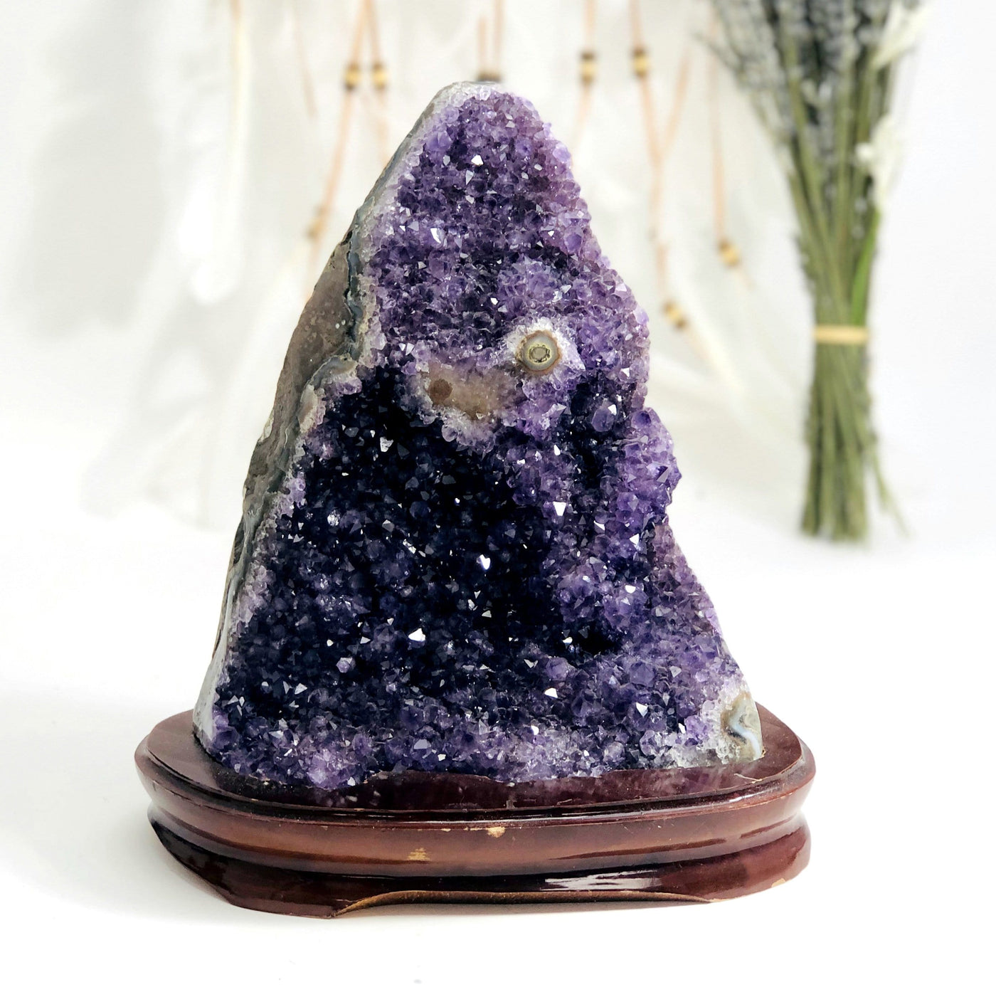 Amethyst Cluster on Wooden Base with decorations in the background