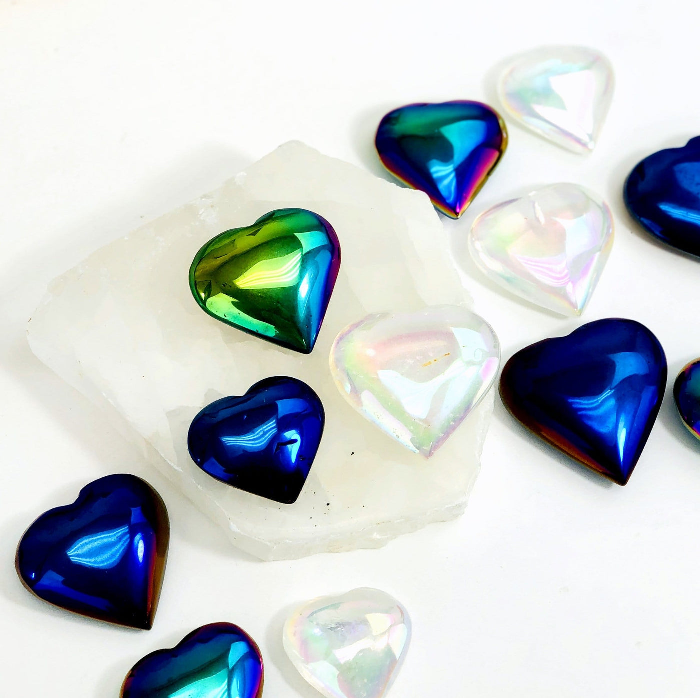 Titanium Coated Hearts display on white background to show they come in Mystic blue Mystic Green and Angel Aura 