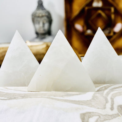 selenite triangle charging plates propped up on display