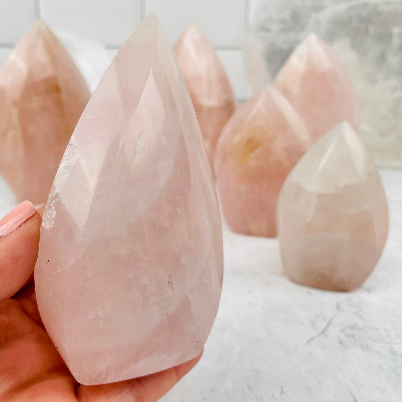rose quartz flame tower in hand for size reference 