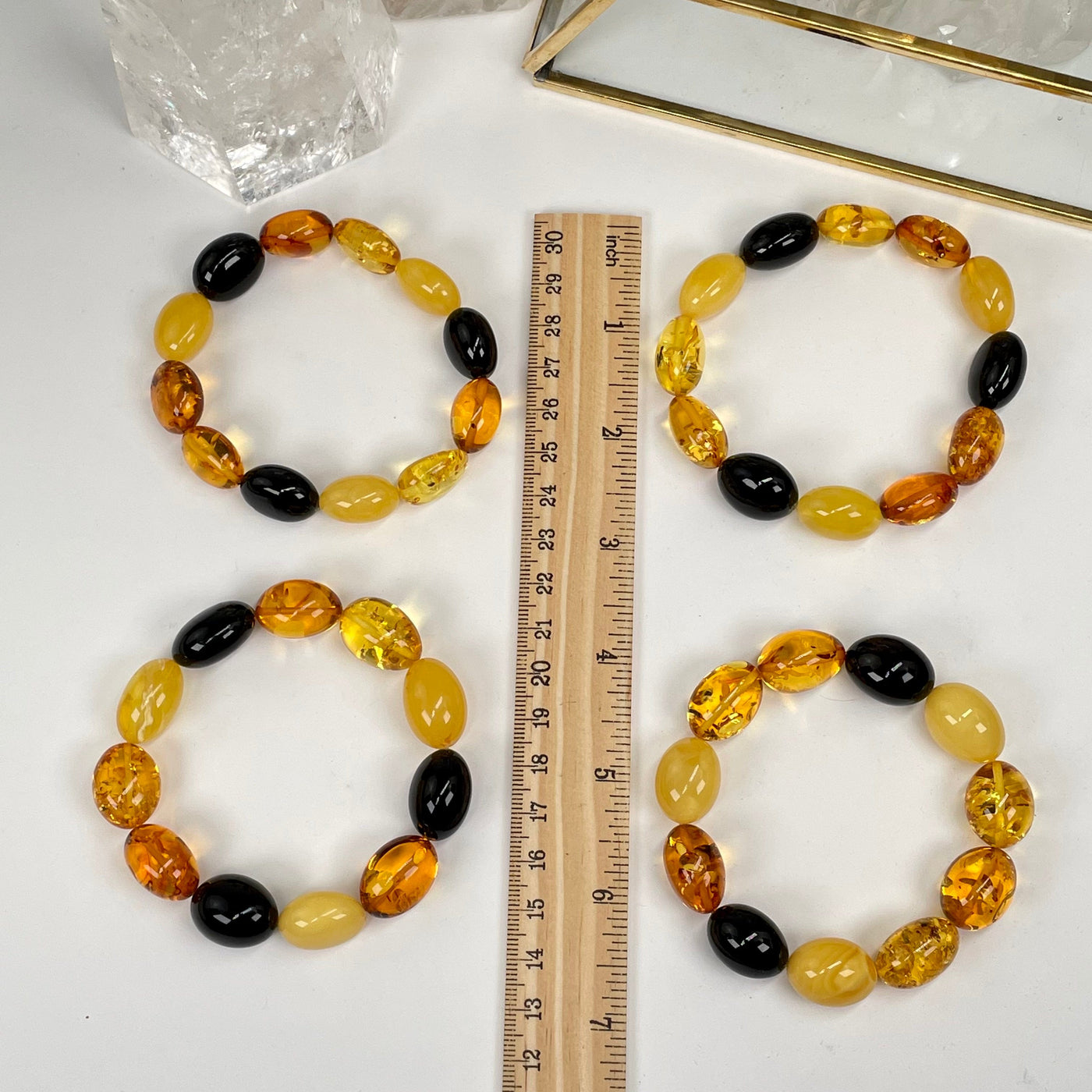 amber bracelets next to a ruler for size reference 