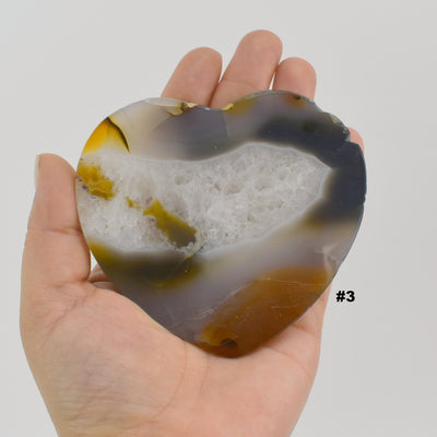 Close up of agate heart slice #3 in a hand.