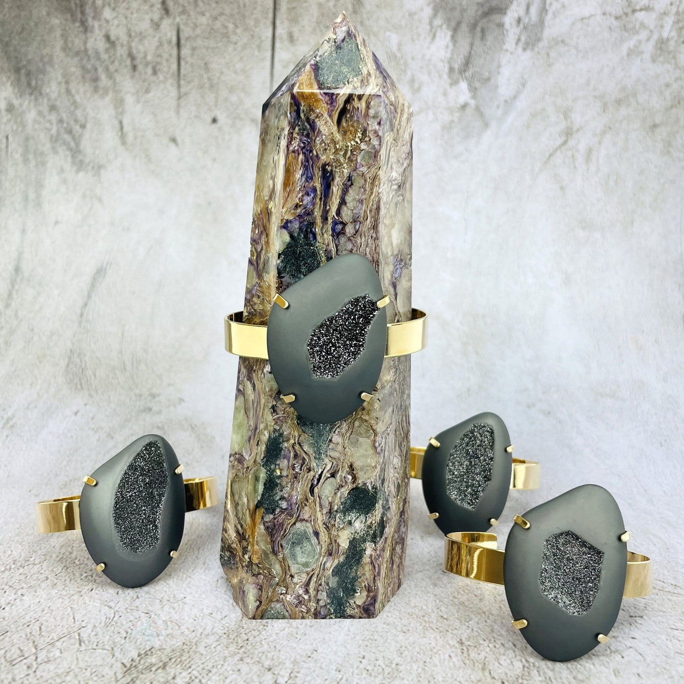 druzy cuff bracelet displayed on crystal tower with 3 others in the background