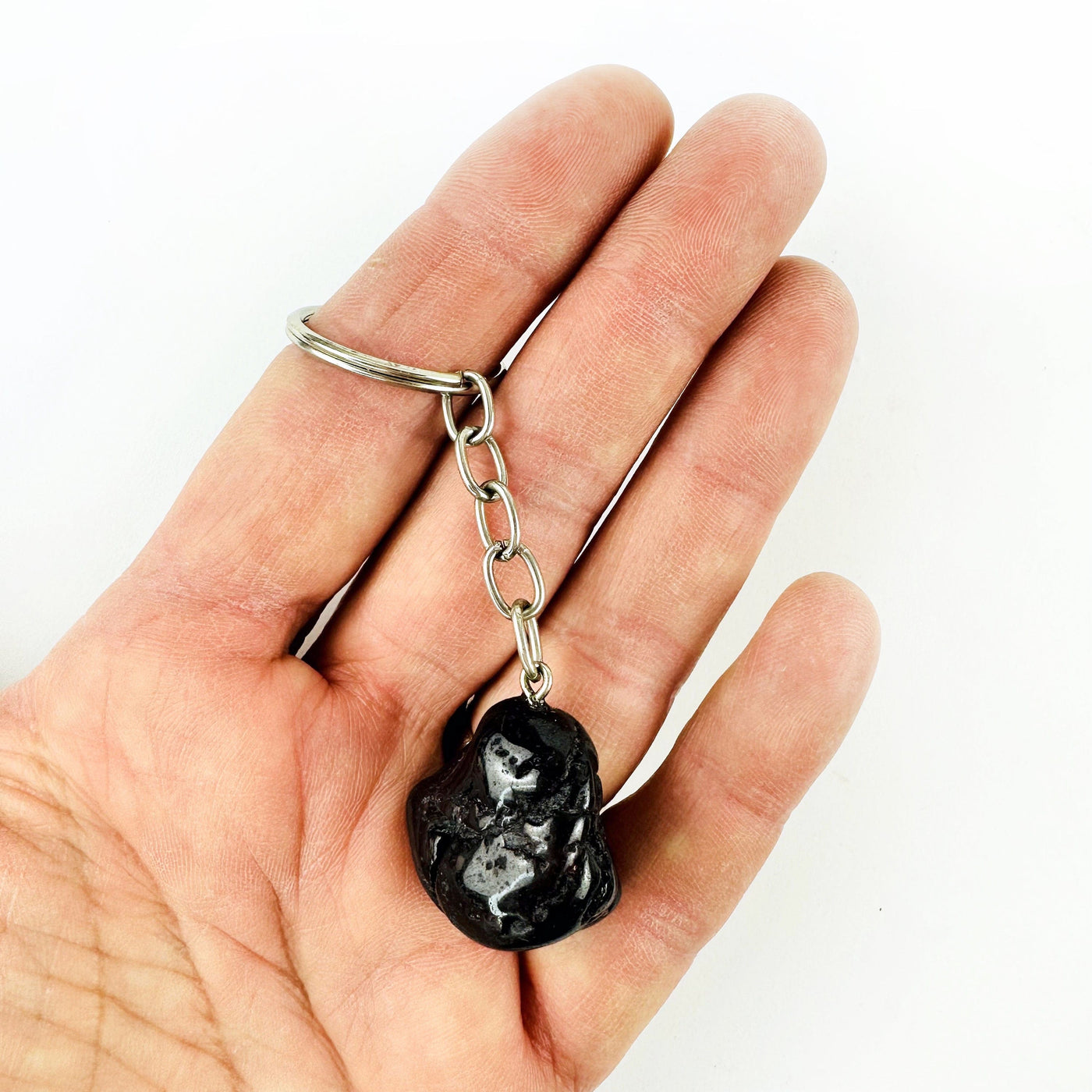 Tumbled Garnet Keychain in a hand for size reference