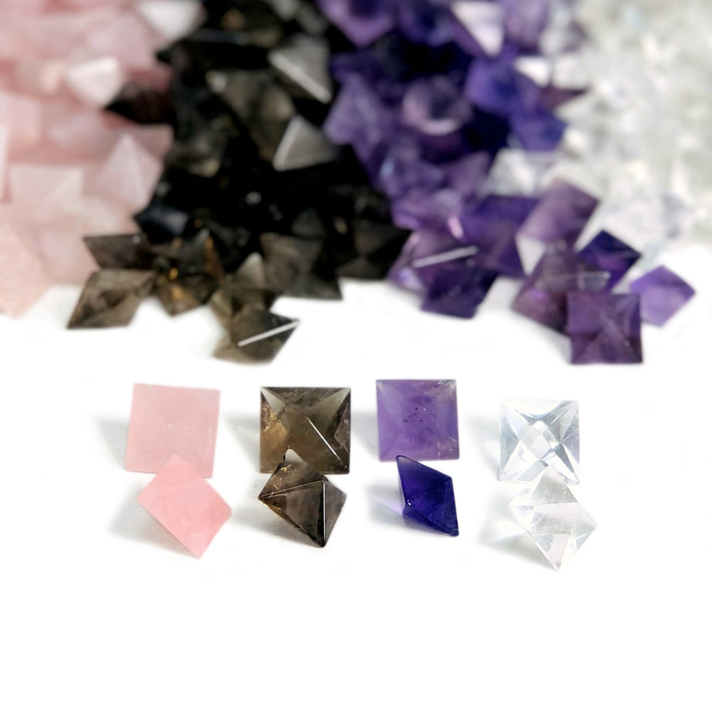 Gemstone Octahedron shown here in rose quartz, smoky quartz, amethysyt, clear quartz, in front with lots of others in background