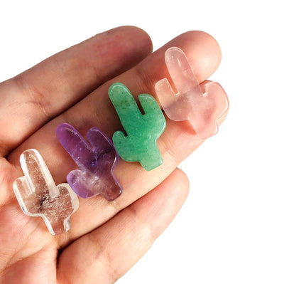 Four different Gemstone Cactus Cabochons displayed in hand.