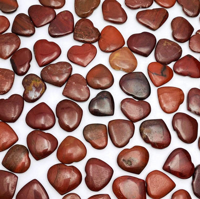 Red Jasper Heart Shaped Stones scattered on white background