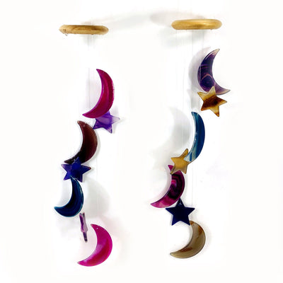 Two Agate Moon and Star Wind Chimes  hung up shown with a white background.