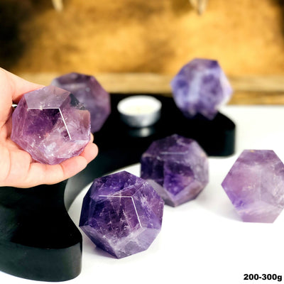 Amethyst Dodecahedron Stones --close shot view of dodecahedron size 200-300 grams in hand for size comparison.
