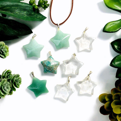 top view of Gemstone Star Pendants with Silver Toned Bail with decorations in the background