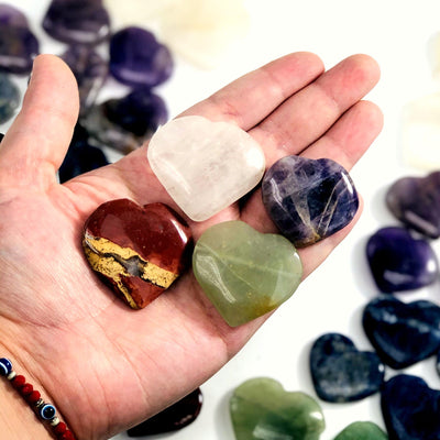 multiple heart shaped gemstones on a hand to show size reference