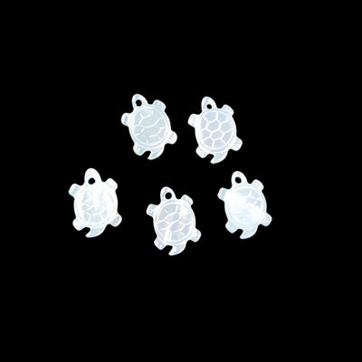 5 mother of pearl turtles displayed on black background to view characteristic differences between each bead