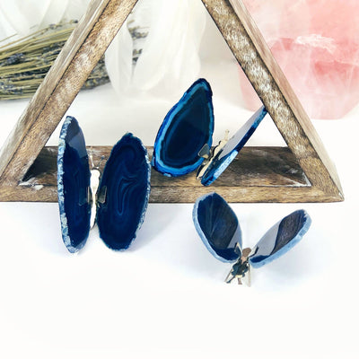 Blue Agate Druzy Butterfly Stands in an alter with crystals and flowers.