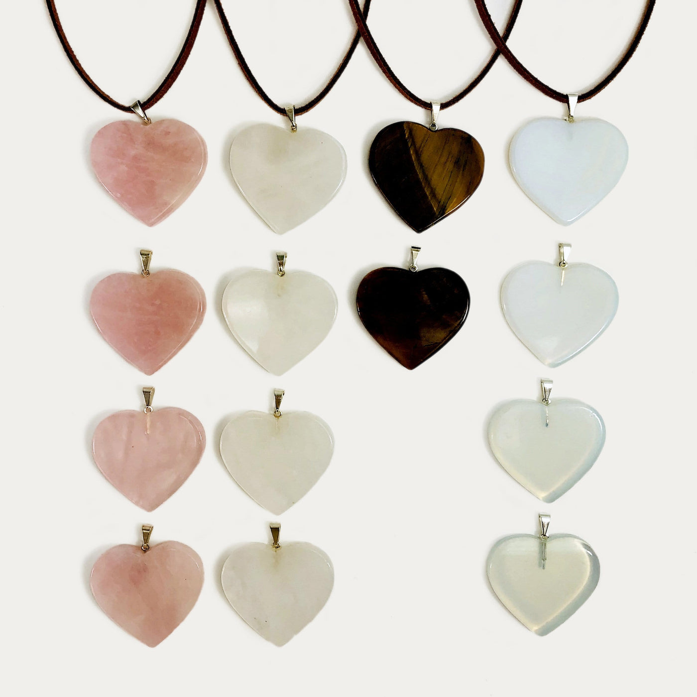 multiple heart slice pendants with silver toned bail with string on them to show as a neckless and some without string 