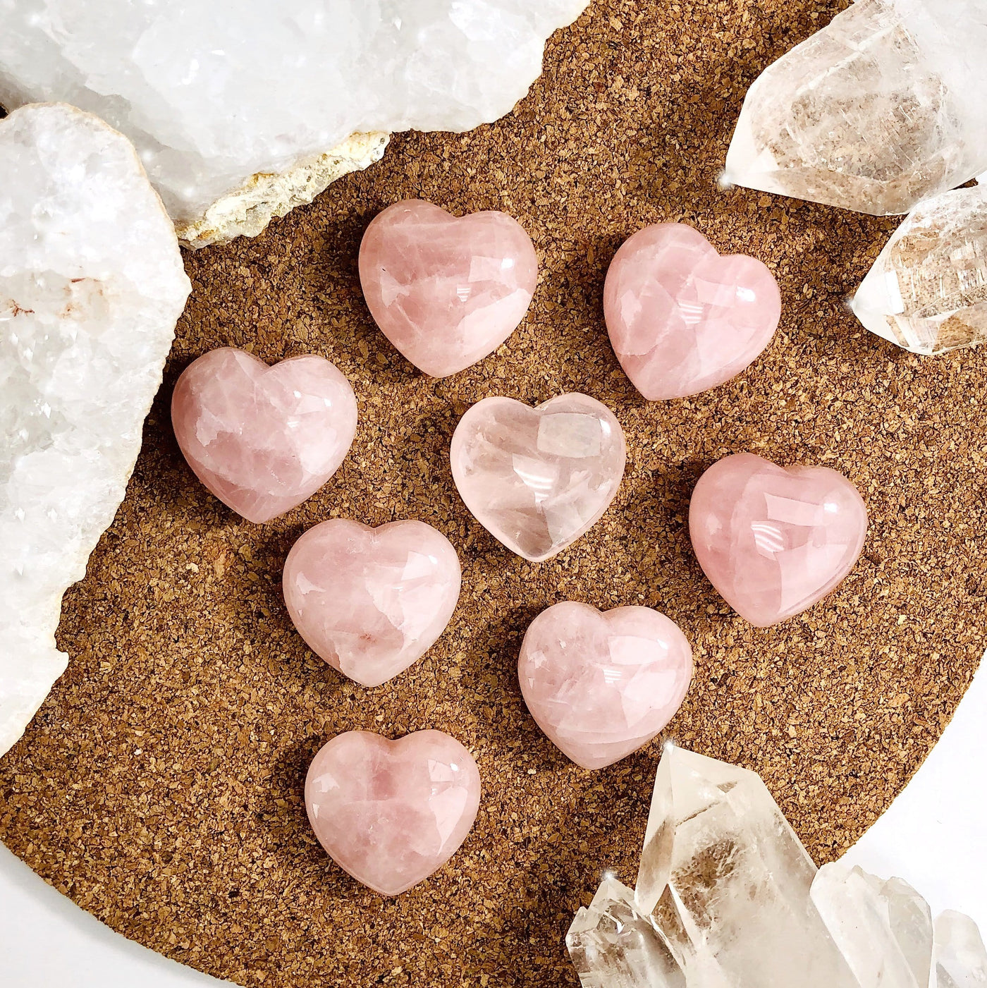 8 Rose Quartz Hearts with other crystals on corkboard