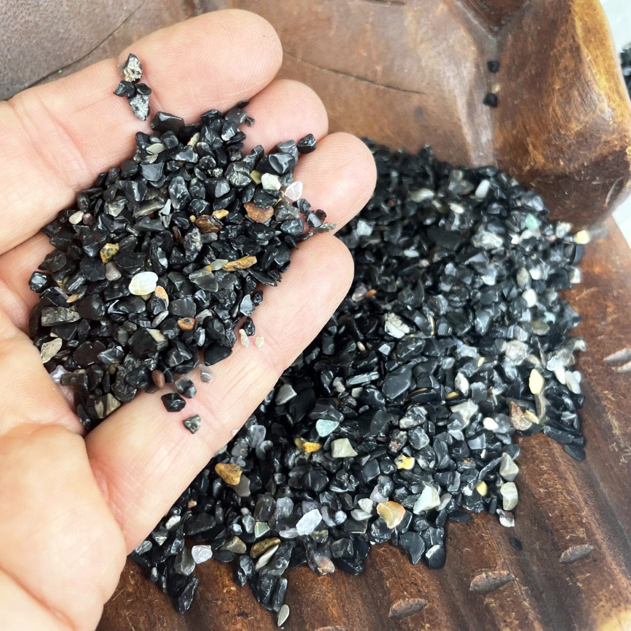 Black Onyx 1lb bag - Tiny Chips in a hand for size