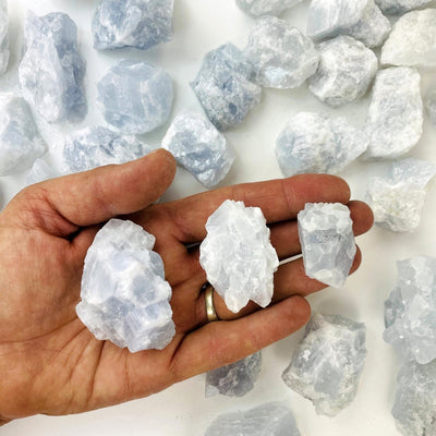 Celestite Stones in a hand to show size variances
