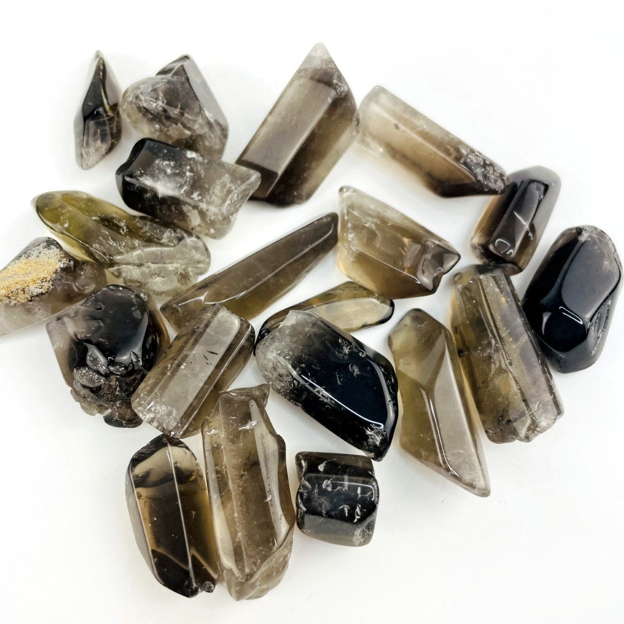 Polished Smoky Quartz Tumbled Stones and Points on a table showing variations