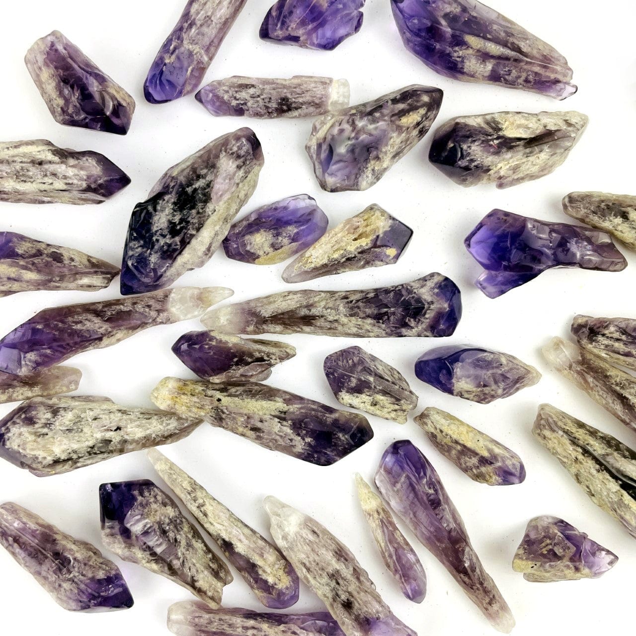 Elestial Amethyst Point - 1 Pound Bag shown spread out on a table