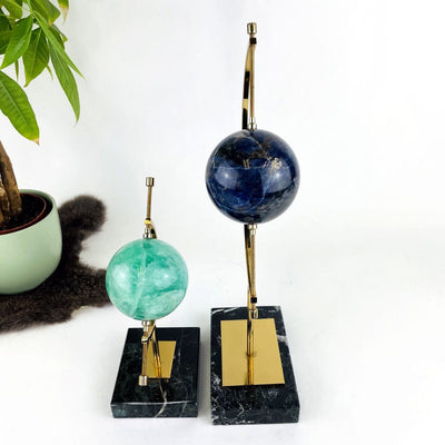 2 Sphere Holders with Caliper with decorations in the background