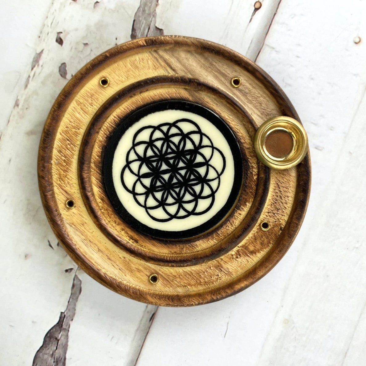 top view of the burner to show the details of the flower of life and multiple incense holder holes. also comes with a cone burner holder 