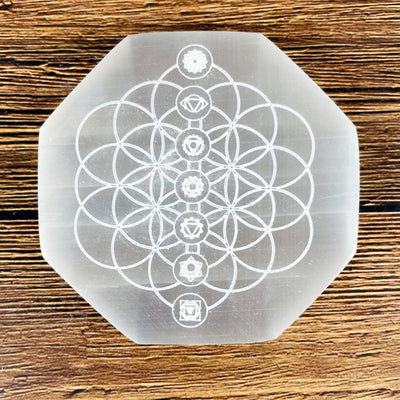 close up of selenite hexagon engraved with flower of life chakras for engraving details