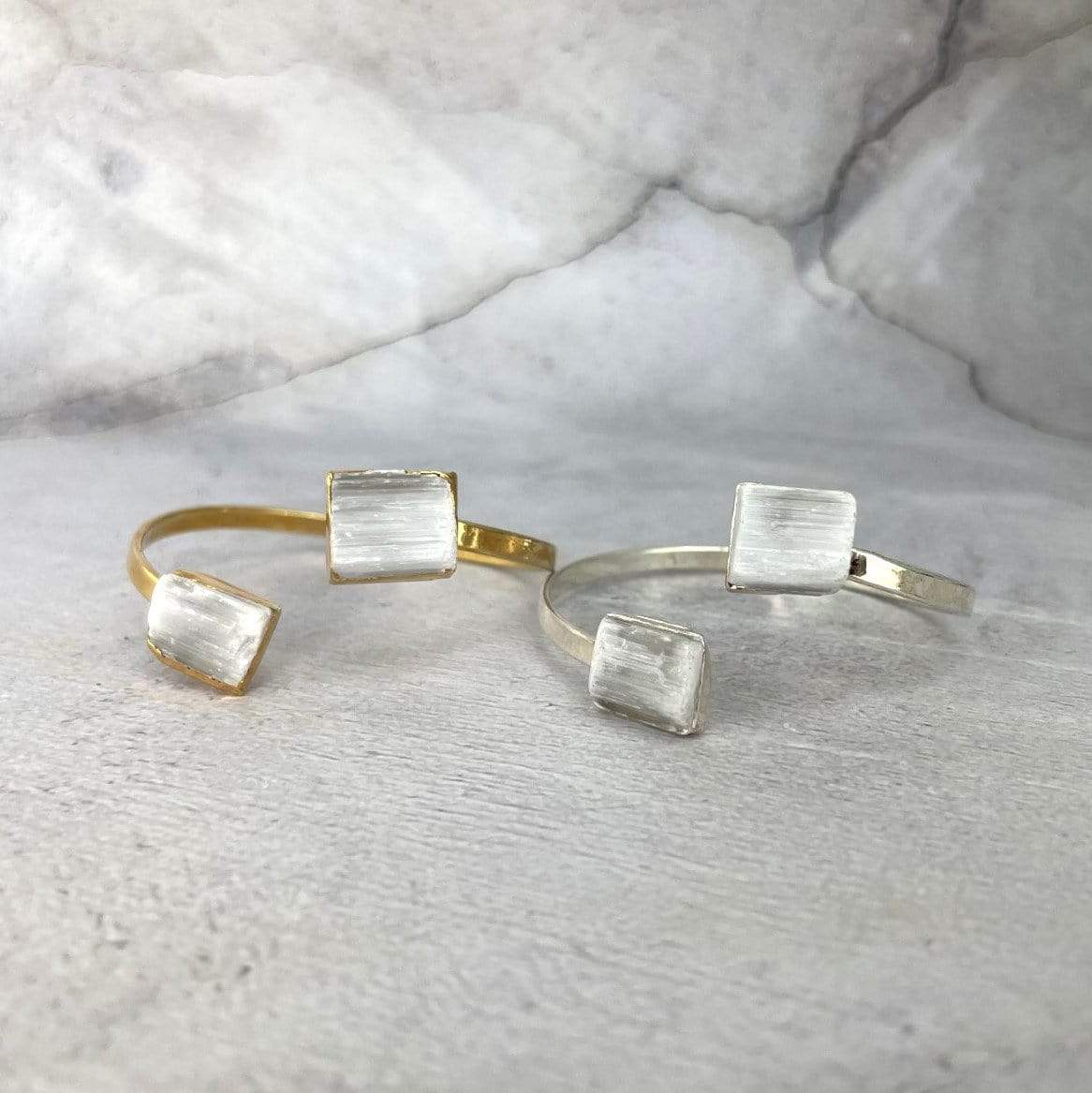 gold and silver selenite cuff bracelets on display