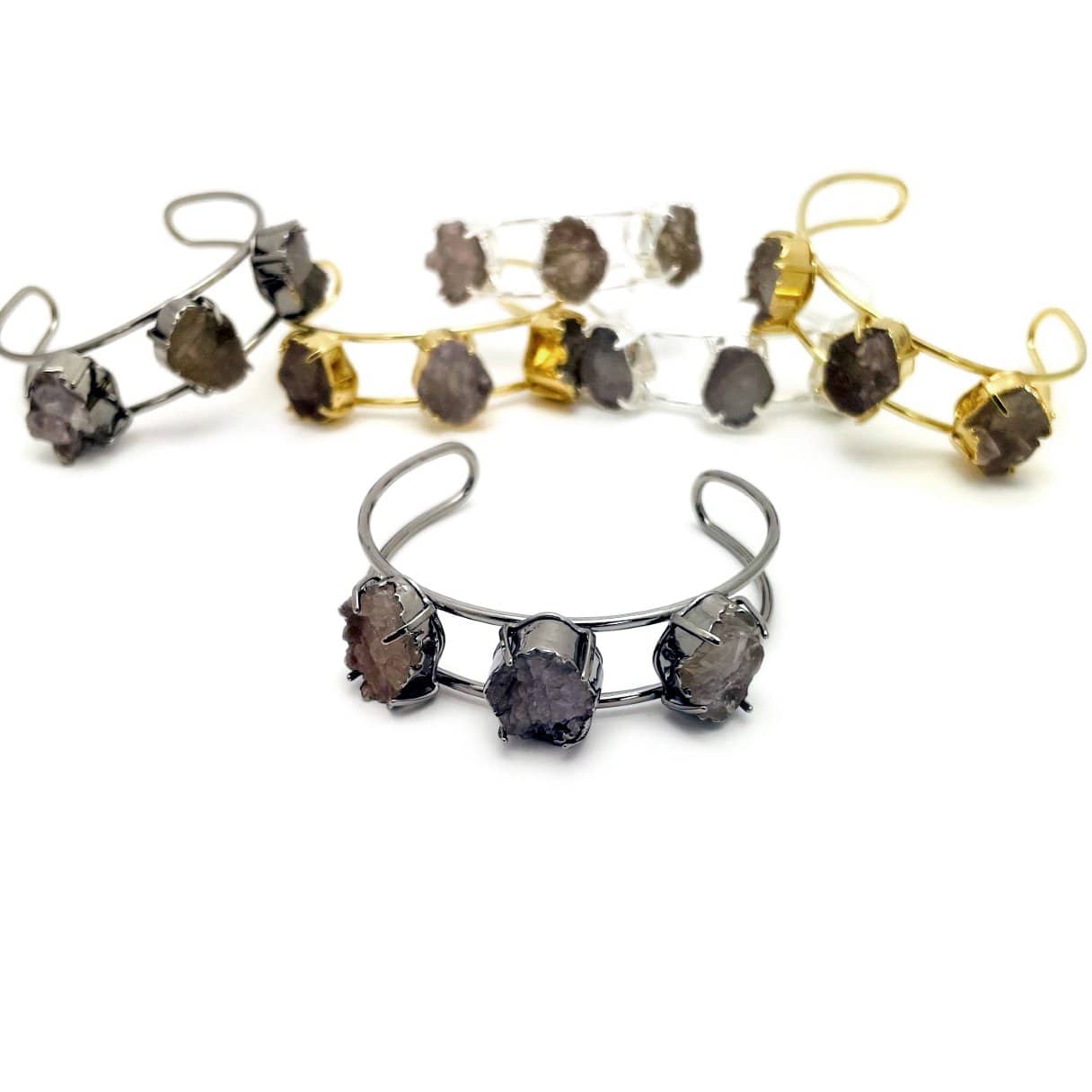 Druzy cuff bracelets in gold plating, silver plating and gunmetal plating on a white background.