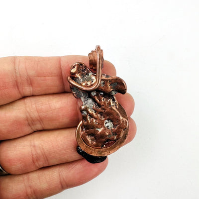 Copper Nugget Pendant in a hand for size reference
